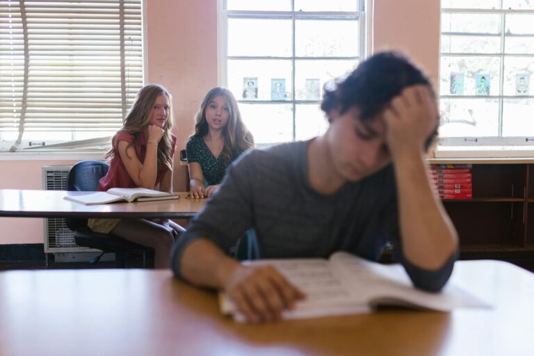 two women bullying a man in the school